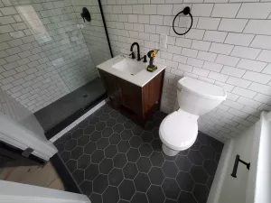 Why Two Bathroom Remodels the Same Size Can Cost Very Different Amounts 3 White subway tiles with black bathroom fixtures