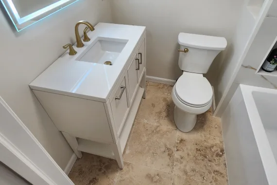 Bathroom remodel in South Philadelphia, 19146, white vanity with gold finish faucet