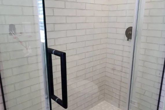 Shower door with black fixtures